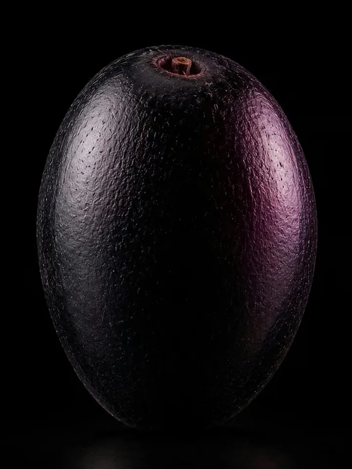 A single whole jamun, studio-lit against black.